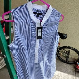 Striped blue and white Tommy Hilfiger sleeveless shirt. Buttons 1/2 way down. Sm